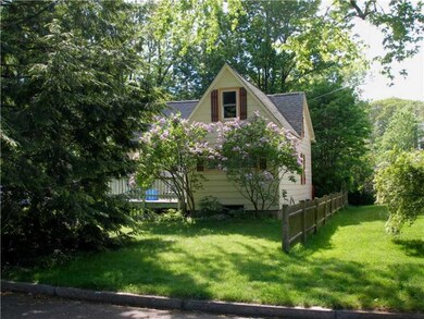 Exterior Front. Lilacs in bloom.
