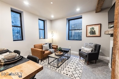 Living room featuring carpet flooring and beam cei