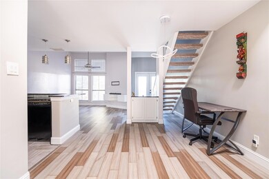 Office area with light wood-style floors, baseboar