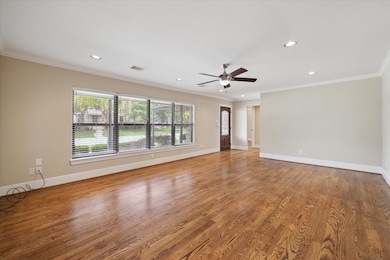 Large living room with entrance, hardwood floors,