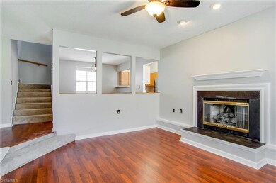 The living room features gas logs, ceiling fan, large window, and new flooring.