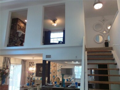 A PEEK OF THE UPPER LEVEL DEN WITH FIREPLACE FROM 