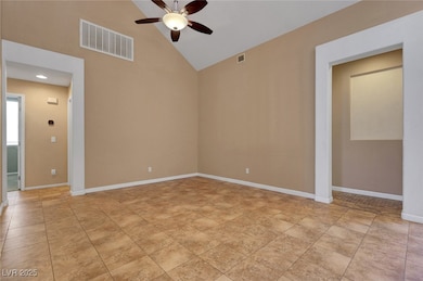 Unfurnished room with a ceiling fan, high vaulted