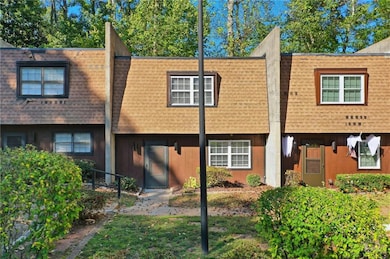 View of front of house with a shingled roof and mansard roof