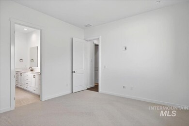 Unfurnished bedroom with light colored carpet, ensuite bath, and recessed lighting