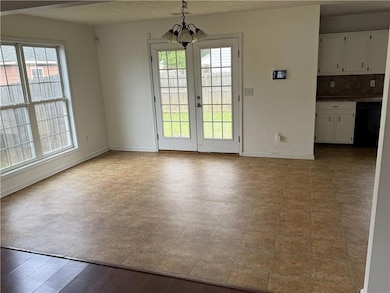 Unfurnished dining area with healthy amount of natural light and a chandelier
