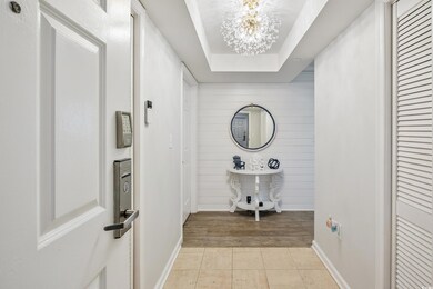 Corridor featuring wood walls, baseboards, a tray 