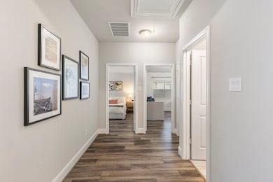 Right next to the office, you'll find a wide hallway, two secondary bedrooms and a Hollywood bathroom. Gorgeous flooring throughout the house.