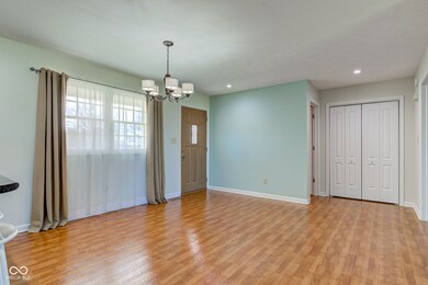 interior space with light wood finished floors, a notable chandelier, recessed lighting, and baseboards
