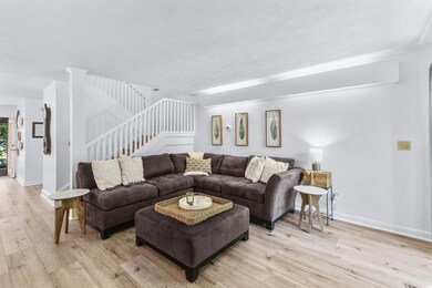 Living area featuring light wood-style floors and stairs
