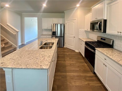 Kitchen featuring a sink, ornamental molding, appl