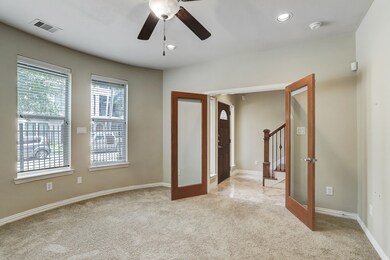Large room with bay windows and storm shutters