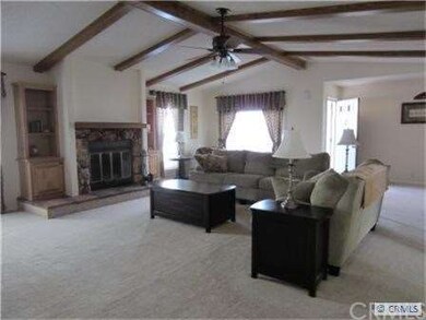 Great room showing beamed ceilings