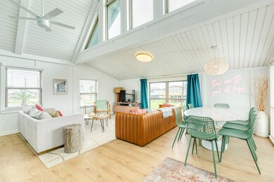 Bright and airy living space featuring high ceilin