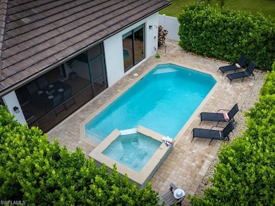 View of swimming pool with a patio area and an in ground hot tub