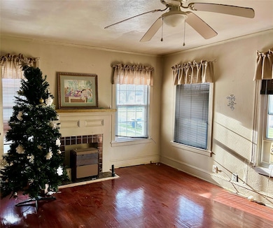 Living area featuring heating unit, a ceiling fan,