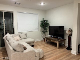 Living room featuring wood finished floors, visibl