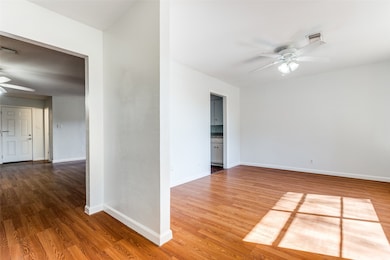 Spare room with a ceiling fan and light wood-type flooring