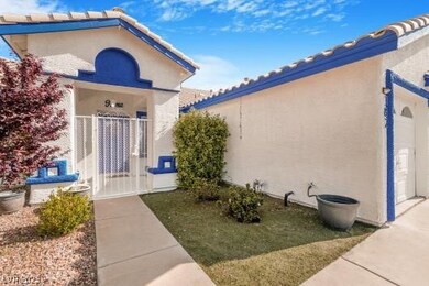 Doorway to property with a tiled roof and stucco s