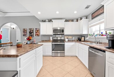 Stainless steel appliances, bright white cabinets
