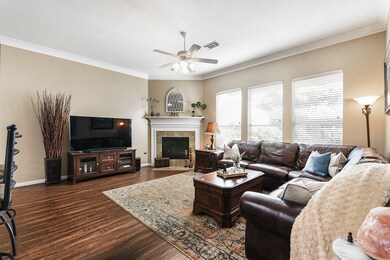 Light and bright living room!  Freshly painted walls, tons of natural light, gas log fireplace, vinyl wood floors, and crown molding.