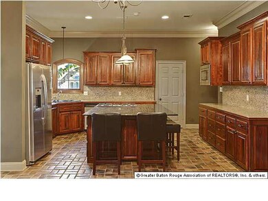 Master Chef kitchen! Gas grill, tons of cabinets, corner sink with two windows, walk in pantry. Island seats 5
