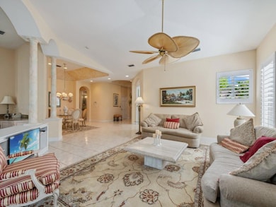 Living room with visible vents, arched walkways, l