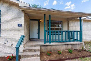 Property entrance featuring covered porch and brick siding
