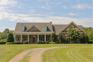Front elevation with garages to the right and in the basement on the left.