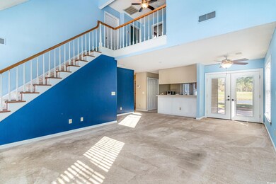 Unfurnished living room featuring ceiling fan, fre