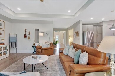 Living area featuring recessed lighting, a raised 