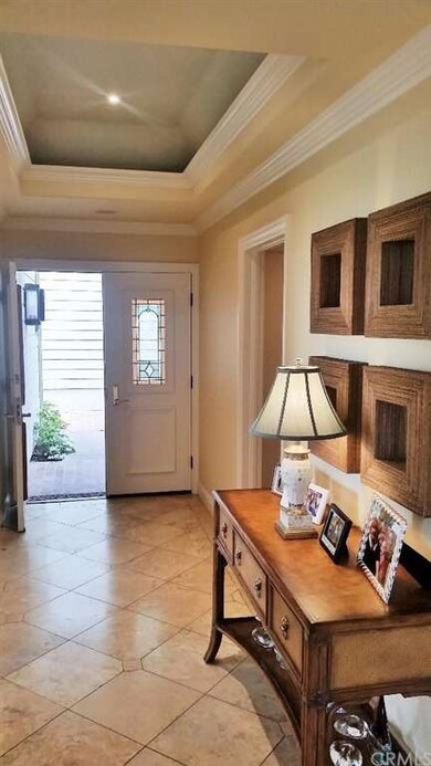 Elegant foyer with gorgeous tray ceiling.