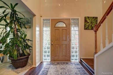 Large Entry Foyer Featuring Designer Glass Block Bordering Entry Door With New Luxury Vinyl  Flooring
