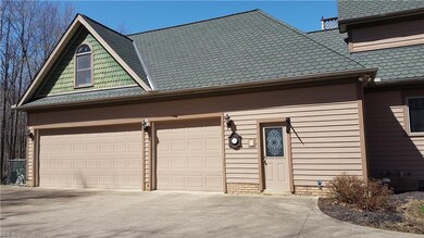 Three car side load garage with service door.