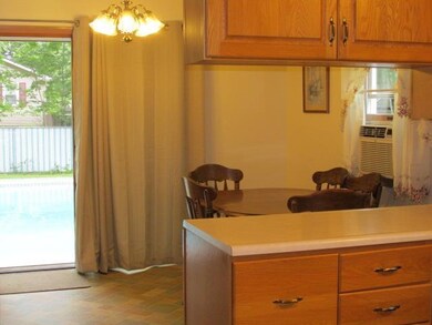 Dining area with view of pool beyond