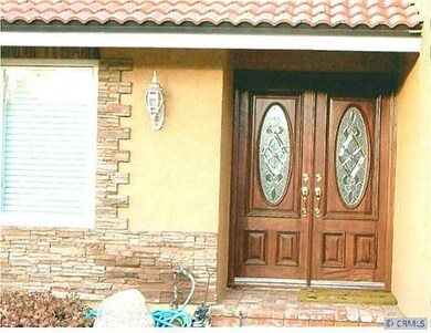 Custom wood and beveled glass double entry doors.