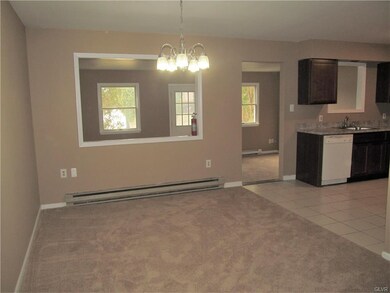 Large dining room is open to the bonus room which 