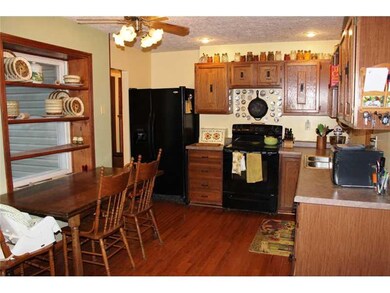 Kitchen. The kitchen has a great farm house window with shelving for decorating or storage.  All of the kitchen appliances stay and the wood flooring is throughout.  There is a cabinet pantry (not shown) around the corner.