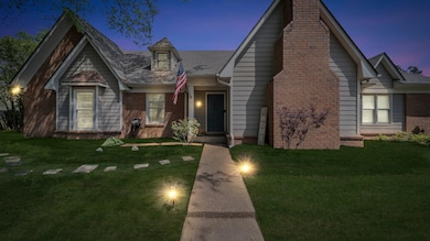 View of front of house featuring a front lawn, bri