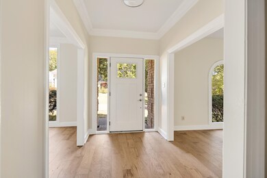 Foyer with ornamental molding, plenty of natural l