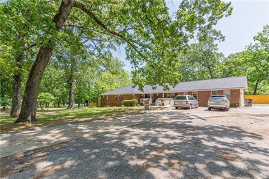 Ranch-style home featuring brick siding, fence, and driveway