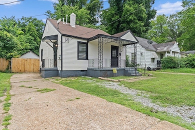 View of front of home with a chimney, covered porch, and roof with shingles