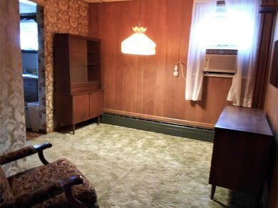 The window A/C unit shown in the formal Dining Roo