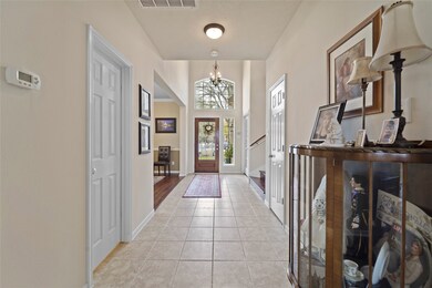 2-story foyer opens to open concept floorplan. Custom upgrades include crown molding and Acacia Hardwood flooring throughout the first floor.