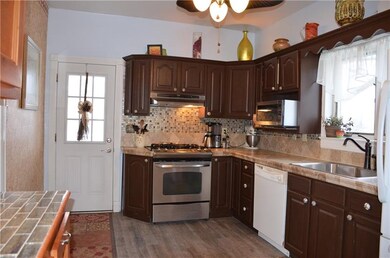New kitchen boasts wood like ceramic floor, glass 