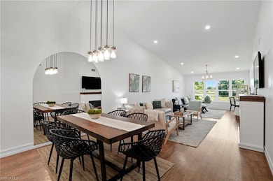 Open-concept layout blends dining and living areas seamlessly, with soaring ceilings and abundant natural light.