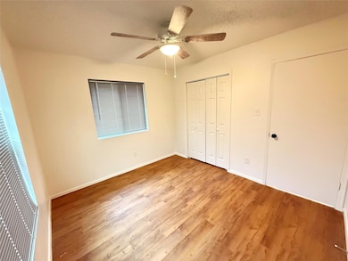 Unfurnished bedroom featuring baseboards, wood fi