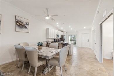 Tiled dining room featuring ceiling fan, lofted ce