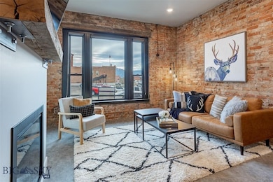 Living room with concrete flooring and brick wall