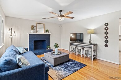 Living room with a fireplace, wood finished floors